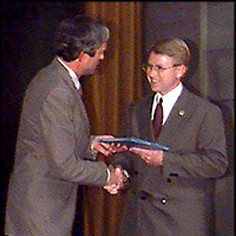 Charles Porter IV accepts the 1996 Pulitzer Prize in Spot News Photography from George Rupp, Columbia University President.