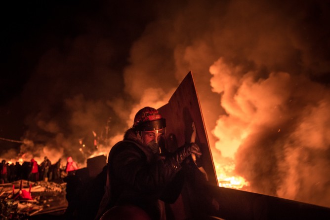 Feb. 19, 2014. Protesters burn barricades to prevent riot police from storming Independence Square in Kiev, Ukraine. (Sergey Ponomarev for The New York Times)