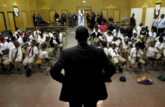 Principal Dr. Stanley Johnson introduces career day guests to the students of the 100 Black Men Community Charter School. The school invited businessmen, police officers and firefighters to mentor the boys and to encourage that they take a career-oriented approach to life. (August 25, 2013)