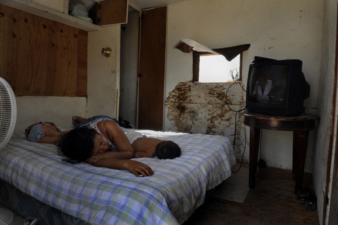 La Joya, Tex.: Maria Olivera sleeps with her 1-year-old son Matthew and daughter Sarai, 2, in a trailer without glass in the windows and with electricity coming from a neighbor via an extension cord. Luisa Colin, director of the Extended Food and Nutrition Program in Hidalgo County, later asked her if she had attended any of the nutrition classes offered by the county, and Olivera said yes. In the isolated area where Olivera lives, the stores tend to carry cheap, filling foods that are also high in sugar an