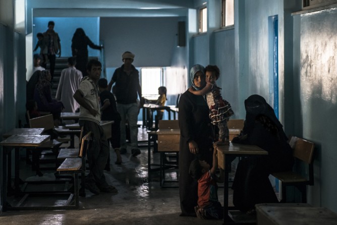 July 19, 2014. Displaced Palestinians take refuge at a school run by the United Nations in Rafah, Gaza. (Sergey Ponomarev for The New York Times)
