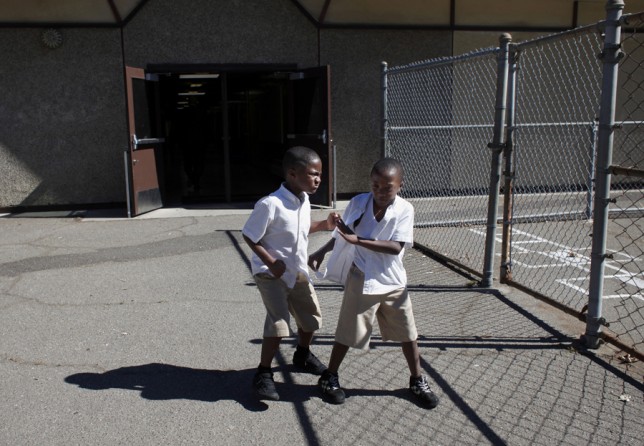 Jeremiah Little and his brother Taric fight on the playground on the last day of the 2012-2013 school year. Because the 100 Black Men Community Charter School let out for the summer later than most Oakland schools, attendance during the last few days of the year dropped and the students became more restive. (August 25, 2013)