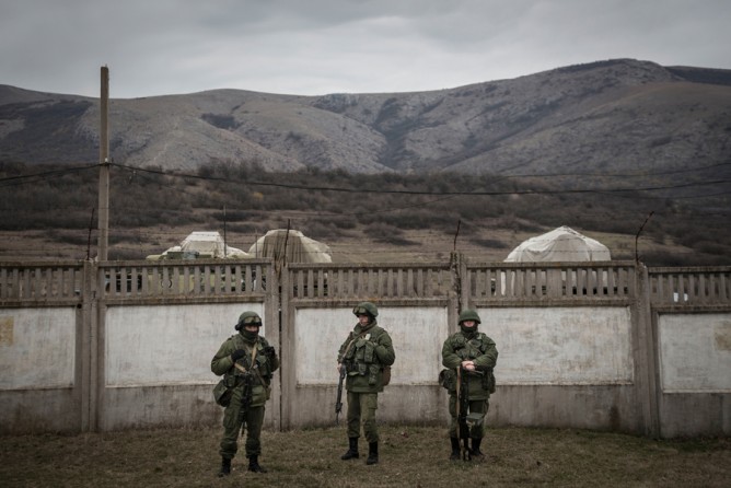March 2, 2014. Armed men outside a blocked Ukrainian military base in the village of Perevalnaya, in the Crimea. (Sergey Ponomarev for The New York Times)