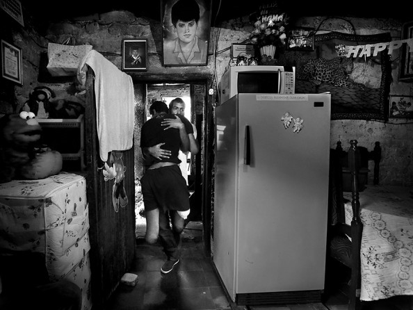 Allan Oliva, 24, carries his brother Marco Oliva, 21, who had his legs amputated after trying to jump on a train heading north through Mexico earlier this year. They live with 11 other family members in a house in Barrio Colonia Divanna dominated by the gang '18', in Tegucigalpa, Honduras, on Friday, July 4, 2014. Oliva's father was killed by gang members in 1995, when he was 2 yrs old. Many young Honduran immigrants leave their country to escape the increasing violence. (Bob Owen/San Antonio Express-News)