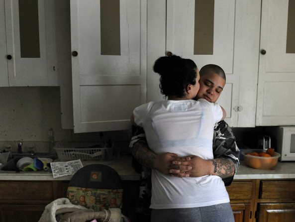 Woonsocket, R.I.: Jourie Ortiz gets some attention from his wife, Rebecka. He was woozy and hardly able to stand after going 48 hours on only about five hours of sleep. He works an overnight shift as a stockboy but then comes home to his family. Years of job losses in Woonsocket, stemming from textile mill closings, have resulted in many people relying on food stamps. (March 16, 2013)
