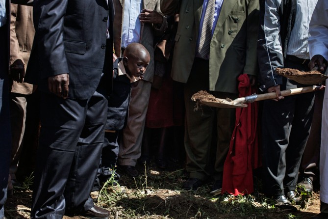 After the siege came the funerals. Simon Kamau, 4 years old, watched as his 26-year-old mother, a cashier at a supermarket in the mall, was buried. (Tyler Hicks, The New York Times - October 2, 2013)