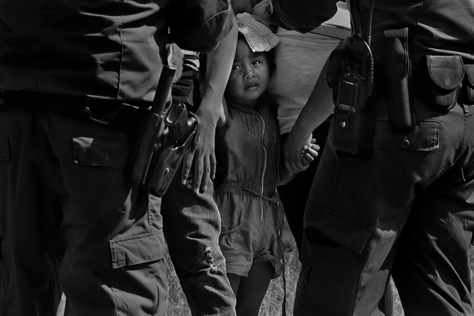 U.S. Border Patrol agents question a group of adult and minor immigrants near Anzalduas Park, southwest of McAllen, Texas, Wednesday, June 11, 2014. A wave of Central American adults with children and unaccompanied minors has overwhelmed U.S. Immigration and Customs detention centers. Immigration officials release some of them on their own recognizance after undergoing processing. (Jerry Lara/San Antonio Express-News)