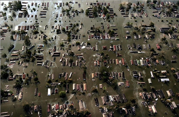 New Orleans, LA -- A patchwork of roofs push through the floodwaters east of downtown, one day after Hurricane Katrina's march through the Crescent City. Floodwaters left the city a horific mix of struggling humanity and swamped infrastructure.