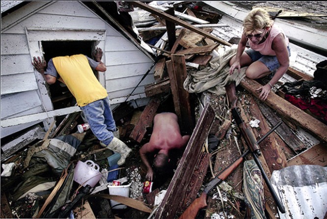 Biloxi, MS -- Tam Cu, Jason Jackson and Linda Bryant looked for belongings from Ms. Bryant's home which was destroyed by the storm.