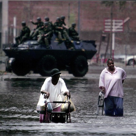 New Orleans, LA -- Tossed together by crisis, 81-year-old Louis Jones (left) and 62-year-old Catherine McZeal join forces to navigate Poydras Street in their trek to the Superdome and a chance at evacuation.