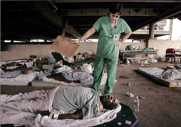 New Orleans, LA -- Memorial Medical Center nurse, Mary Jo D'Amico, fanned a patient waiting in the hospital's parking garage for helicopter transport from New Orleans.
