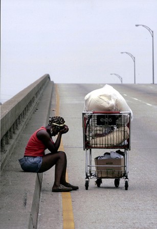 New Orleans, LA -- Kimi Seymour, 27, took a break from pushing her few remaining possessions along Interstate 10.