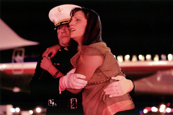 At the first sight of her husband's flag-draped casket, Katherine Cathey broke into uncontrollable sobs, finding suport in the arms of Major Steve Beck. When Beck first knocked on her door in Brighton, Colo., to notify her of her husband's death, she glared at him, cursed him, and refused to speak to him for more than an hour. Over the next several days, he helped guide her through the grief. By the time they reached the tarmac, she wouldn't let go.