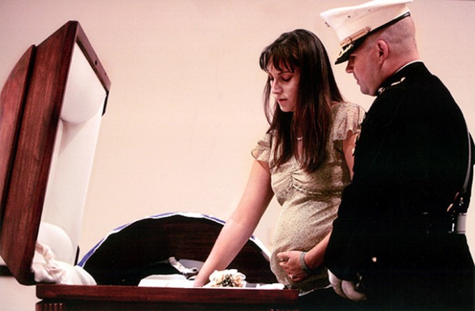Since James Cathey was killed in a massive explosion, his body was delicately wrapped in a shroud by military morticians, then his Marine uniform was laid atop his body. Since Katherine Cathey decided not to view her husband's body, Maj. Steve Beck took her hand, and pressed it down on the uniform. "He's here," he said quietly. "Feel right here."