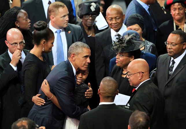 President Barack Obama shares a hug with Eliana Pinckney, daughter of Rev. Clementa Pinckney, at the funeral for the slain pastor of Emanuel AME Church at TD Arena in Charleston. The president eulogized Pinckney, who also was a state senator, in a stirring 38-minute tribute that concluded with Obama singing “Amazing Grace.” (Paul Zoeller, The Post and Courier - June 26, 2015).