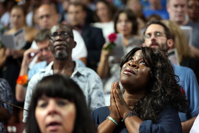 The hymn "What a friend in Jesus" rings out at College of Charleston's TD arena as thousands of residents, including Ra'Dana Dalton, gather one block from the Emanuel AME church for a community memorial service. The City of Charleston held the service so people could honor and remember the nine people shot to death at the church two days before (Grace Beahm, The Post and Courier - June 19, 2015).