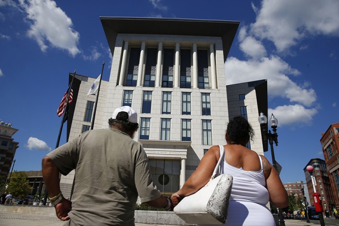 Raquel and her Uncle Bobby make their way towards the Suffolk County Juvenile Courthouse, to go before a judge and find out what will be necessary to get the girls back (Jessica Rinaldi, The Boston Globe).