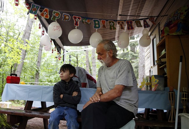 During Strider's sixth birthday party, Lanette and her mother make the 15 minute drive to Walmart to pick up his cake. Having been gone over two hours, a disappointed Strider sits beside Larry and waits for them to return to begin his party (Jessica Rinaldi, The Boston Globe).