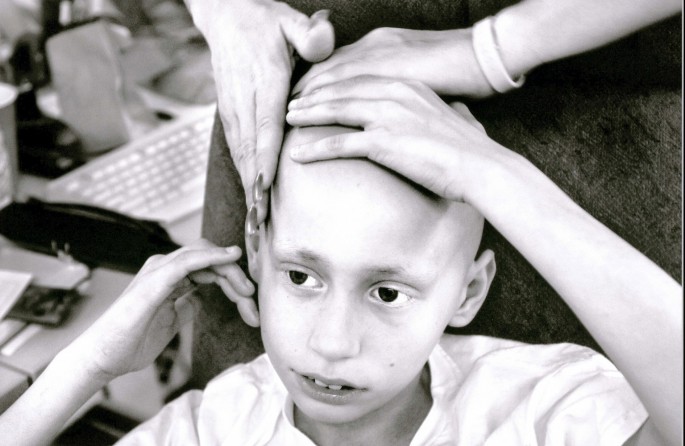 Derek Madsen, 10, gets a soothing massage from his mother, Cyndie French, at her Sacramento nail and tanning salon. "I'm going to do whatever it takes to make him happy, to see him smile." Cyndie says. A single mom of five, Cyndie had to give up her salon at a financial loss to care for her dying son. 