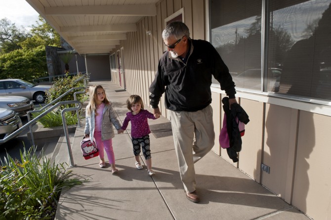 Don Hatfield joins hands as he takes his two granddaughters Eva, 5, left, and Ariel, 3, center, to their first day at St. John's Lutheran School in Napa. (May 16, 2012)