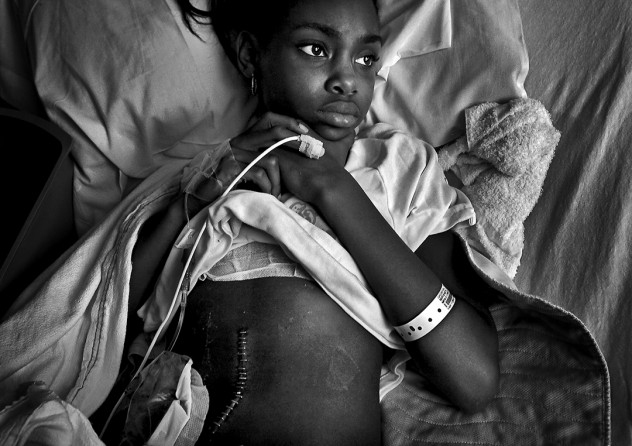 Ten-year-old Erica Miranda was shot three times in the back, knee and hip while playing basketball outside her home in Compton. A young man had walked up to the crowded street corner and started firing a handgun in what police believe was a gang assault. A 17-year-old relative and a 45-year-old family friend, both men, were also shot three times and survived. At Long Beach Memorial Medical Center: Miller Children’s Hospital, Erica waits for her bandage to be changed. (Barbara Davidson, Los Angeles Times - D