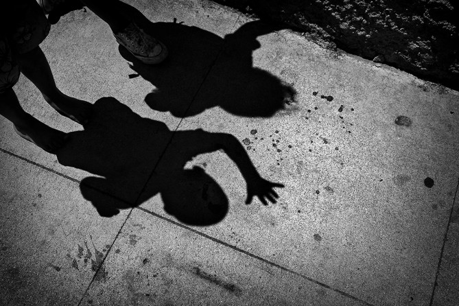 Blood from the shooting remains on the sidewalk where Josue and his sister Katherine wave to a passing ice cream truck. Upon seeing the stains, Josue has said to his mother, ‘A bad man shot me.’(Barbara Davidson, Los Angeles Times - December 30, 2010)