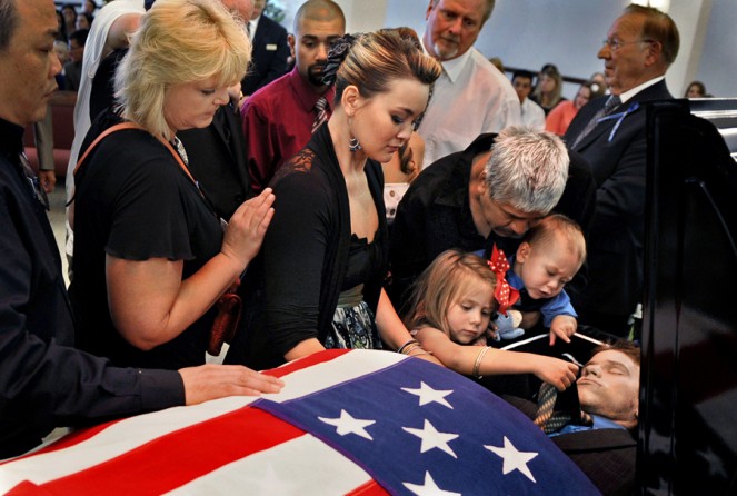 Chantel Blunk, center, says good-bye to her husband, Jonathan Blunk, surrounded by family and friends and her two children, Maximus Blunk, 2, and Hailey Blunk, 4, on Friday, August 3, 2012, during a full military funeral at Mountain View Mortuary in Reno, Nevada. (RJ Sangosti - August 3, 2012)</i>