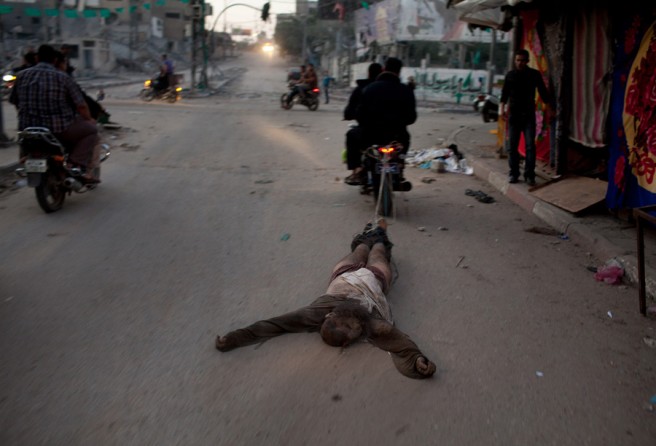 The body of a suspected collaborator being dragged through the streets of Gaza City. (November 20, 2012)
