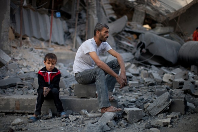 A man and boy amid the rubble of a destroyed home in Gaza. (November 26, 2012)