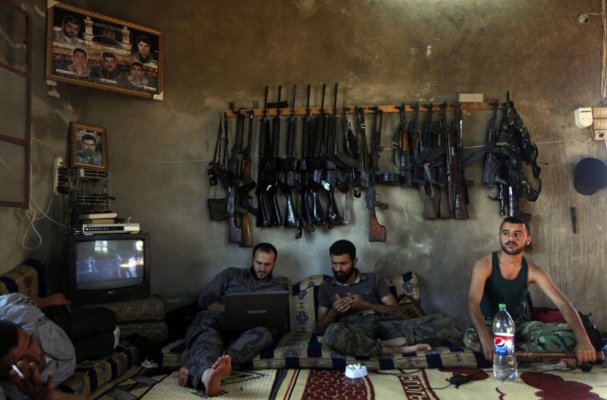 Free Syrian Army fighters sit in a house on the outskirts of Aleppo, Syria, June 12, 2012. (Khalil Hamra, Associated Press - June 12, 2012