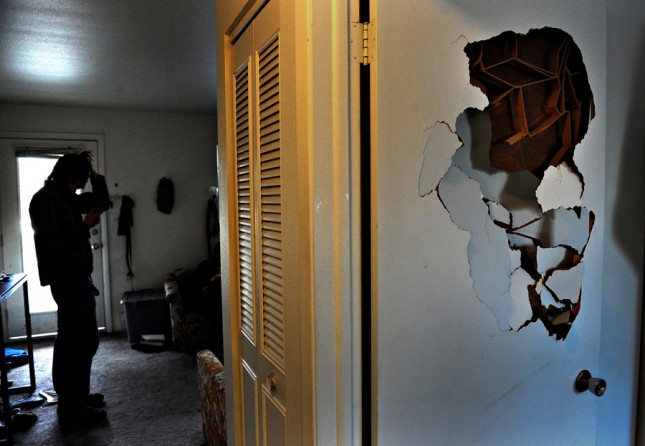 After punching a hole in his bedroom door, Scott panics in his living room. 'My PTSD comes from long exposure to combat trauma,' Scott said. 'I think it comes from the fact that I survived. That wasn't my plan. It's an honor to die for my country, but I made it home.' Scott said that being diagnosed with PTSD 'means I have nightmares every night. It means I'm hyper-vigilant -- It means I have no fuse and if I get attacked, I'm going to kill. 'I don't want to feel this way.' (Craig Walker, The Denver Post - 
