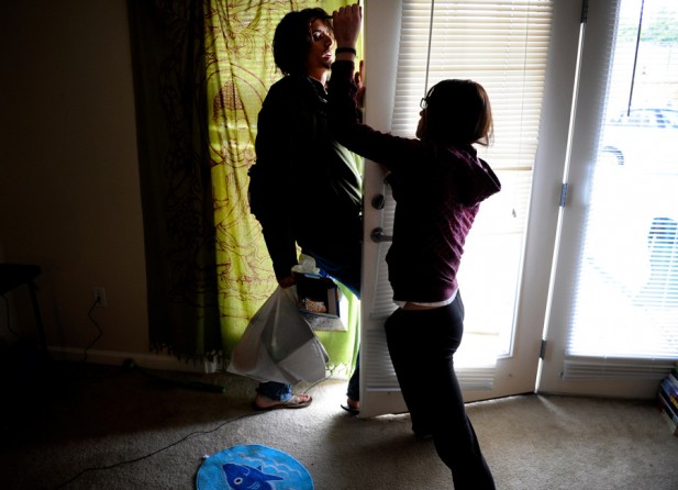 Scott tries to leave his apartment as his girlfriend seizes his glasses. 'She steals my glasses because I can't see without them. She antagonizes me. She does it to push my buttons, but I'm not going to do anything. I'm not going to hit her,' he said.  'I dated this girl for almost two years, and it was the most tumultuous relationship I have ever had in my life. It was the closest thing that got me back to the levels of stress I had in combat.' (Craig F. Walker, The Denver Post - December 29, 2011)