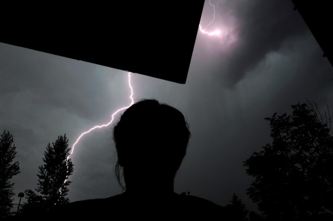Scott watches an evening storm roll in outside his apartment. 'I'm just feeling guilty about the things I did. I was a brutal killer, and I rejoiced in it. I was bred to be a killer, and I did it. Now I'm trying to adapt and feel human again. But to feel human, I feel guilty. I did horrible things to people... That's why I can't eat: I feel guilty, I feel sick.' (Craig F. Walker, The Denver Post- December 29, 2011)