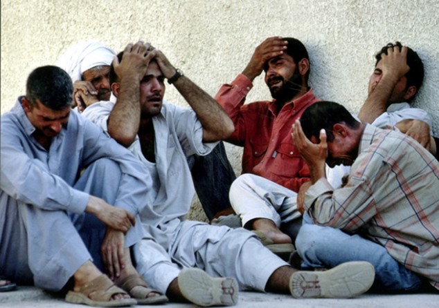 Baqouba - At a hospital morgue, relatives mourn the death of Iraqi national guardsman Ryaad Khudayar, one of at least four guardsmen killed in a car bombing at a checkpoint outside Baqouba. 