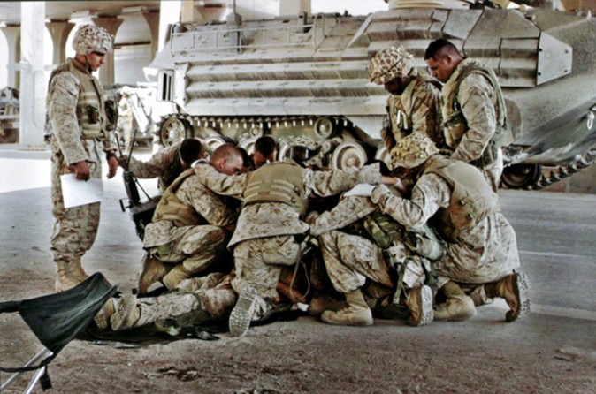 Fallujah - U.S. Marines pray over a fellow Marine killed while fighting insurgent strongholds. 