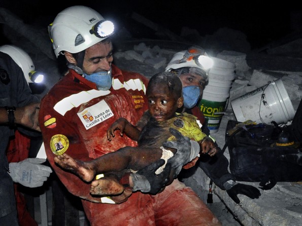 'Rescue' Relief efforts were severely hampered by the fact that government agencies and international organizations charged with helping coordinate assistance operations had themselves been shattered by the quake. But there were moments of hope amid the despair: A tiny baby named Reggie Claude is rescued from the rubble of his home. Disaster relief workers and family members rejoiced as Oscar Vega carried the child through the streets. (Carol Guzy, The Washington Post - January 14, 2010)
