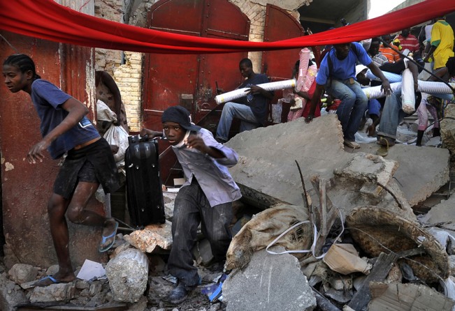 'Chaos' Desperate Haitian survivors take goods from stores in the market area of Port-au-Prince as chaos erupts in the streets. The price of what few staples remain in the city had soared, fuel supplies had dwindled, and thousands of Haitians had abandoned listing homes for squalid tent cities springing up in even the smallest public spaces. Public parks and tennis courts filled with families carrying what possessions they had left. (Carol Guzy, The Washington Post - January 16, 2010)
