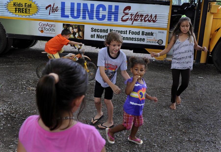 Greenville, Tenn.: Children make their way off the Lunch Express bus after getting a meal. Scores of poor children are served lunch each weekday in the areas around Greeneville. Because so many poor families to not have access to transportation, the bus comes to them. They must eat on the bus, and finish within 15 minutes, because the bus must make many stops over a wide area every day. (July 7, 2013)