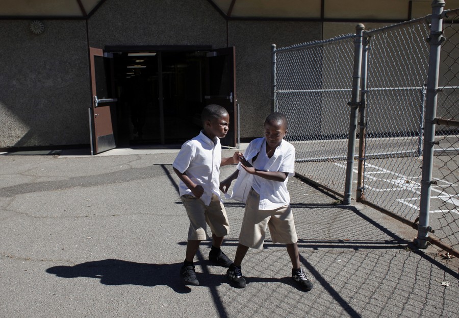 Jeremiah Little and his brother Taric fight on the playground on the last day of the 2012-2013 school year. Because the 100 Black Men Community Charter School let out for the summer later than most Oakland schools, attendance during the last few days of the year dropped and the students became more restive.  (August 25, 2013)
