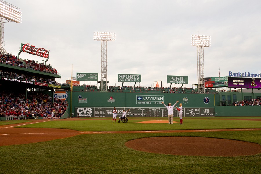 Bauman and Carlos Arredondo, the bystander who had helped him, were introduced at Fenway Park on May 28 before throwing the ceremonial first pitch for a Boston Red Sox game. (Josh Haner, The New York Times - May 28, 2013)