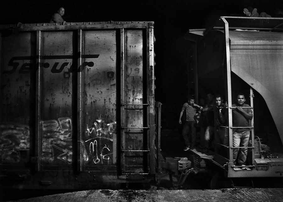 Immigrants ride the train known as 'la bestia' as it leaves Arriaga, Mexico, at 1:30AM. Friday, Aug. 1, 2014. The train system running north from the Guatemala-Mexico border transports thousands of Central American immigrants through Mexico. Immigrants have been killed or have lost limbs after falling off the top of trains. (Bob Owen/San Antonio Express-News)