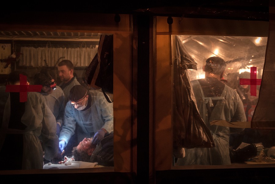 Feb. 19, 2014. Medical volunteers treat the wounded in a makeshift hospital at Independence Square in Kiev. (Sergey Ponomarev for The New York Times)