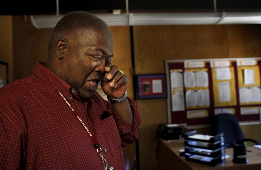 Sixth-grade teacher Peter Wilson wipes his tears as he says goodbye to Dr. Stanley Johnson on the last day of school. Throughout the year, Wilson grew fond of many of the boys, but both he and Johnson were fired at the end of the school year. (August 25, 2013)