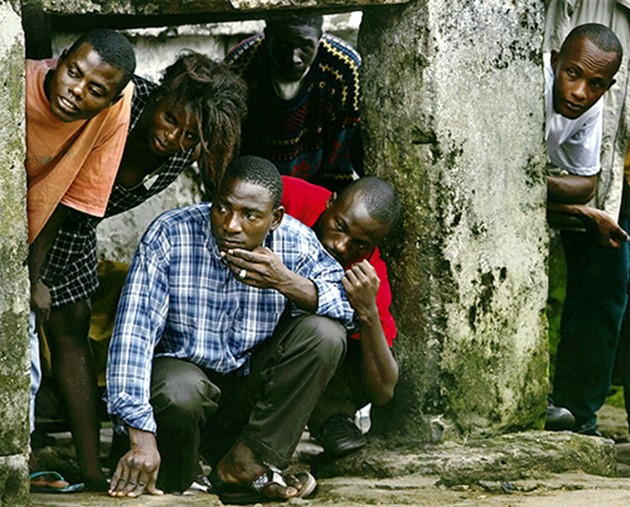 WAITING OUT THE STORM: Residents take cover during an artillery battle in the city center. (Carolyn Cole)