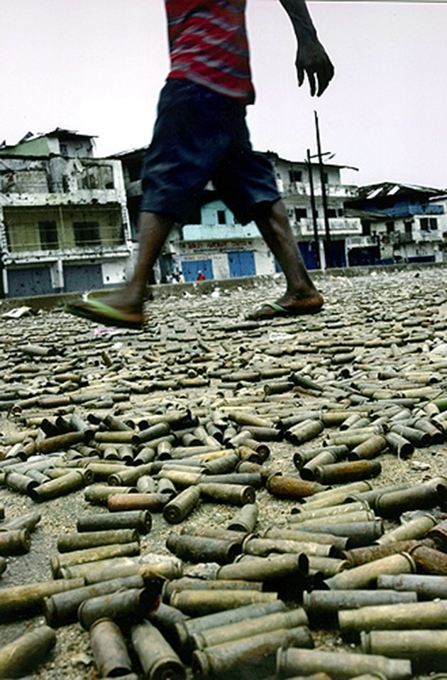 WAR UNDERFOOT: Bullet casings carpet a street in Monrovia, at the heart of the battlefield between government and rebel soldiers. Businesses closed for weeks as the battle raged. (Carolyn Cole)