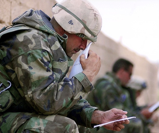 After three weeks and 300-plus miles of speed-and-maneuver warfare, Master Gunnery Sgt. Frank Cordero savors the first letters from his wife, Melissa. "I held that first one for about five minutes... Just to smell it and hold it." (Cheryl Diaz Meyer)