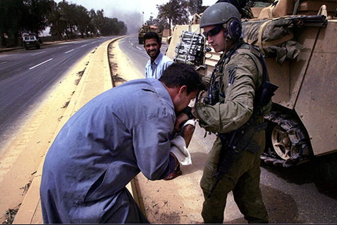 As Capt. Andy MacLean and fellow troops of the 3rd Infantry Division pushed deeper into Baghdad, they were greeted with mixed reaction. While some Iraqi civilians were resentful of American presence, others extended their warmth with smiles, waves, and in some instances, a kiss on the hand... a sign of respect. (David Leeson)