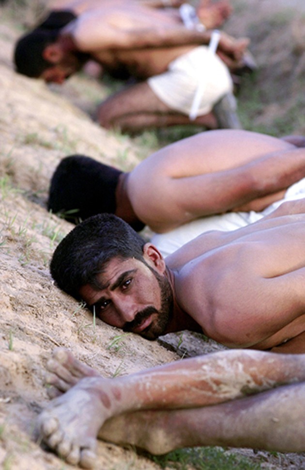 A pained stare, plastic ties and muddy, shoeless feet. In war, everyone is suspect. After a short firefight in Sayyid Muhammad, these men were rounded up, stripped, interrogated and later released. (Cheryl Diaz Meyer)