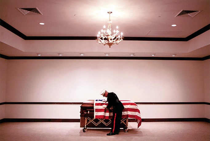 Marine Major Steve Beck prepares for the final inspection of 2nd Lt. James J. Cathey's body, only days after notifying Cathey's wife of the Marine's death in Iraq. The knock at the door begins a ritual steeped in tradition more than two centuries old; a tradition based on the same tenet: "Never leave a Marine behind." When the wars began in Afghanistan and Iraq, Maj. Steve Beck expected to find himself overseas, in the heat of battle. He never thought he would be the one arranging funerals for his fallen co