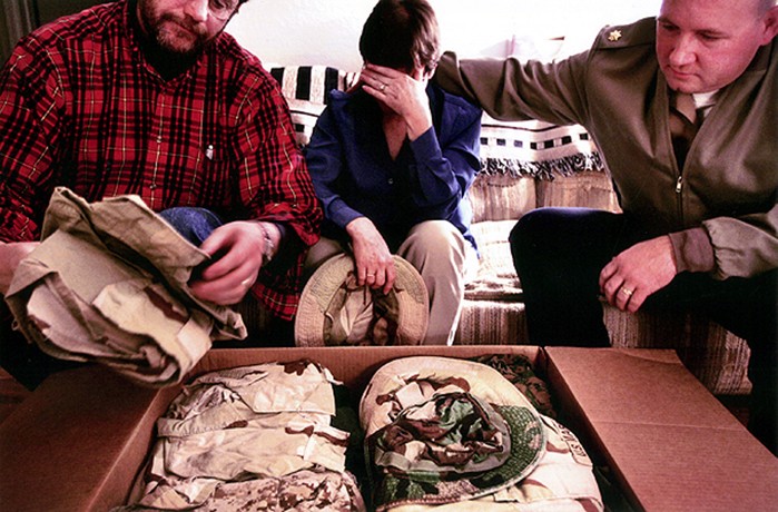 Jo Burns cries as she and her husband Bob opened the boxes containing their son's uniforms from Iraq -- boxes delivered by Maj. Steve Beck. "For me, having all this back is a good thing," she said a few minutes later. "I want to remember. I don't ever want to forget, or to stop feeling." Bob Burns then took her hand. "I don't want to forget either," he said. "I just don't want to hurt."